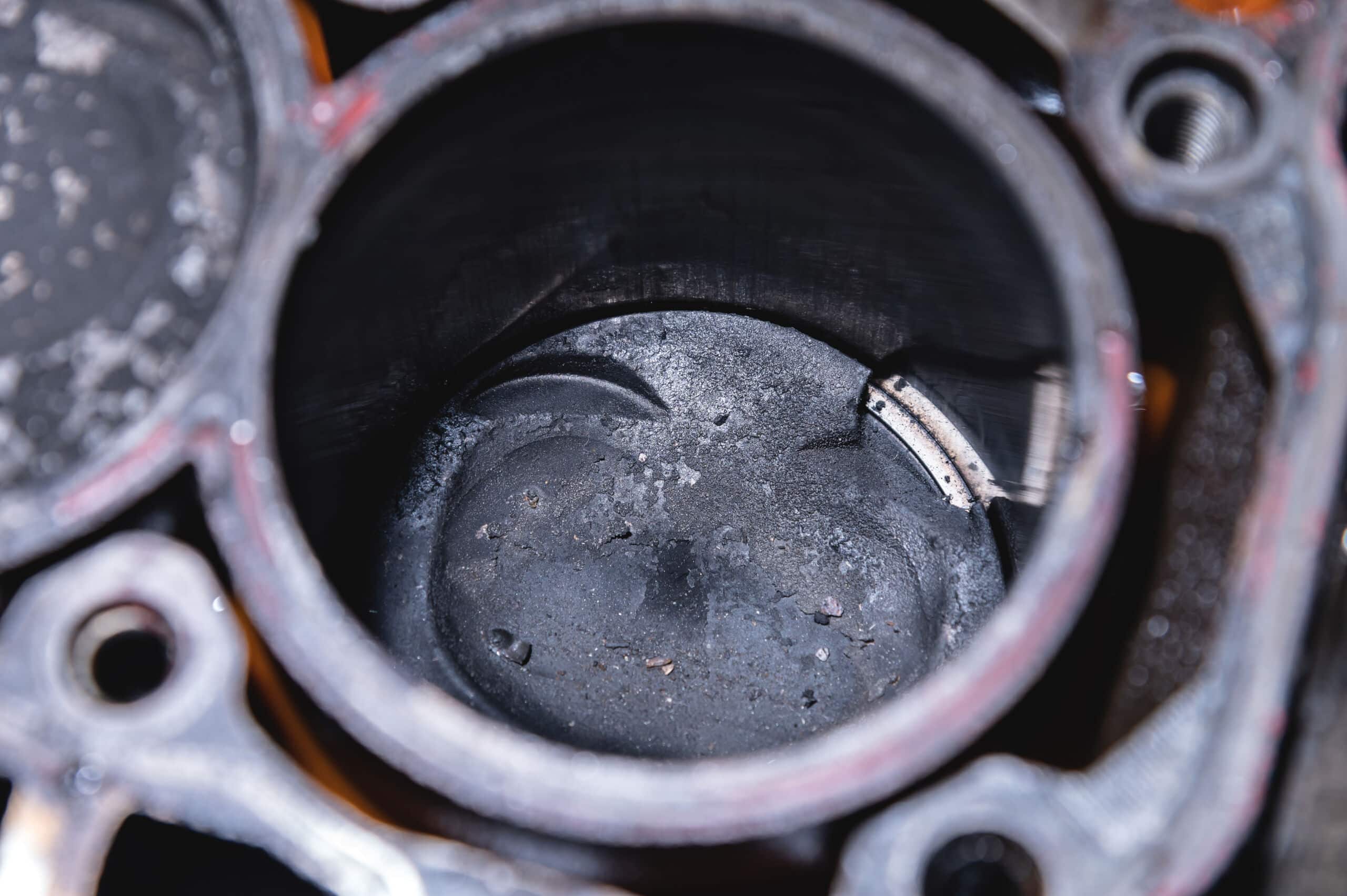 Carbon deposits inside a combustion chamber affecting engine performance.
